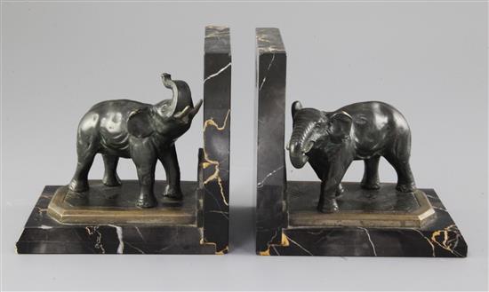 A. Marionnet. A pair of Art Deco bronze and variegated marble bookends, modelled as elephants, 5.75in.